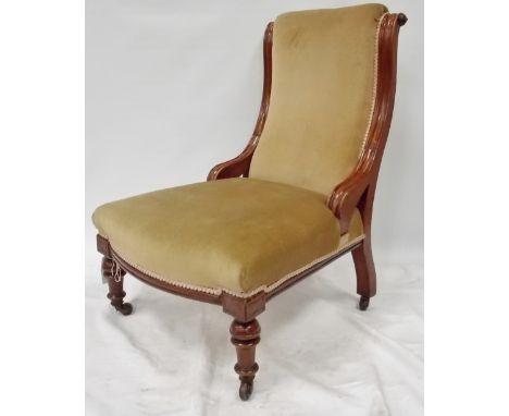 Victorian walnut framed nursing chair, the upholstered back with scroll carved supports over  a stuff over seat, upon turned 