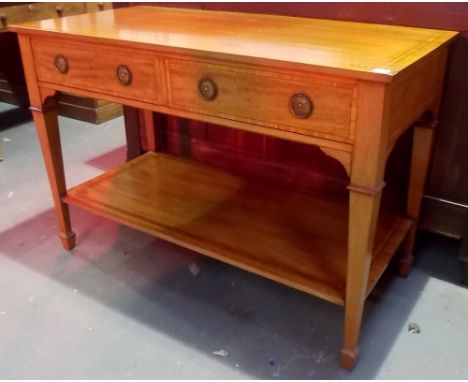 Early 20th Century mahogany satinwood banded two tier side table, the frieze with two  drawers over an open shelf and square 