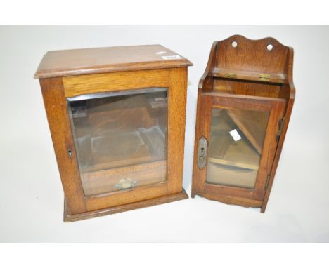 Edwardian oak smokers cabinet with glazed door enclosing a single drawer and pipe racks,  together with a smaller oak smokers