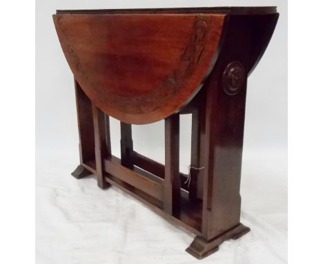 Pre-War oak oval gate-leg dining table, the top carved with a stylised foliate band over wide  supports with flower head boss