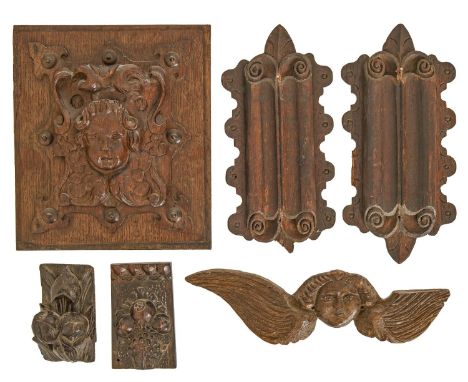 A Baroque oak architectural panel, late 17th/early 18th c,&nbsp;carved and centered by a putto mask on an s-scroll cartouche,