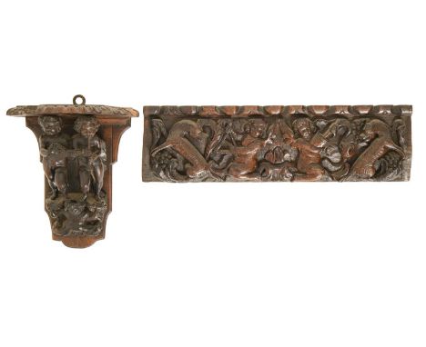 A North European oak figural group of two musicians, 17th c,&nbsp;each putto holding an instrument, later mounted as a wall b