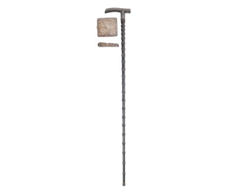 A Chinese silver-mounted ebony walking cane, probably Shanghai, c. 1900,&nbsp;the handle chased with a ferocious dragon, tape