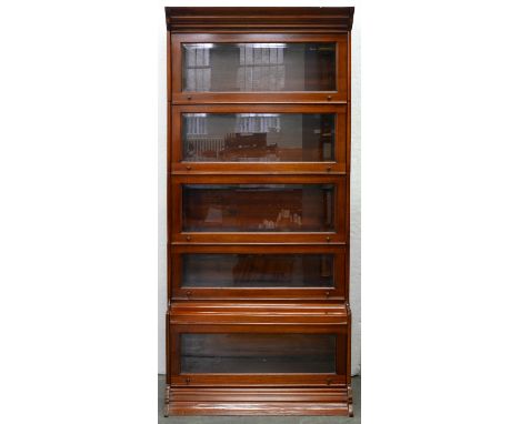 A mahogany sectional bookcase, early 20th c, each of the five sections with bevelled glass light to the up-and-over door, 191