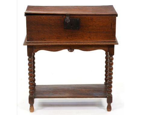 A George III boarded oak box, with iron lock plate and hasp, the interior with a till, mounted on later bobbin turned stand, 