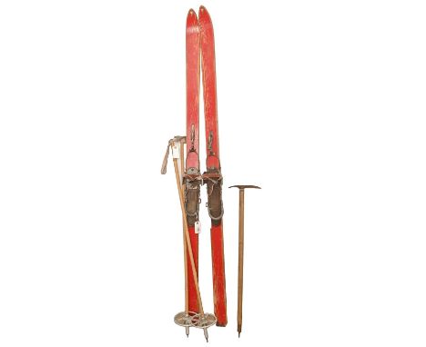 Vintage ski equipment, including skis, bamboo ski poles and a mountaineering axe  