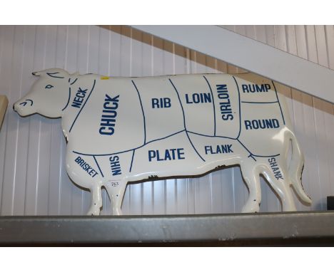 An enamel cow sign