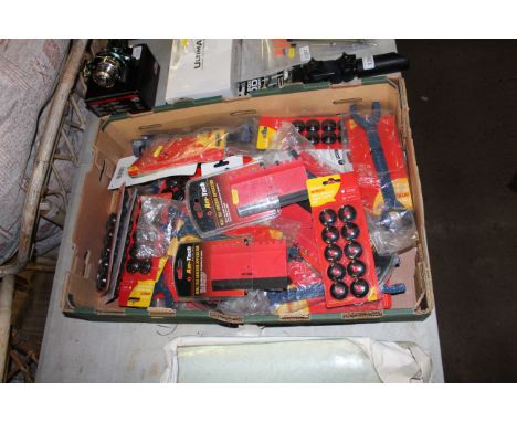 A cardboard tray containing various wall tile adhesive applicators, replacement tarpaulin eyelets etc.