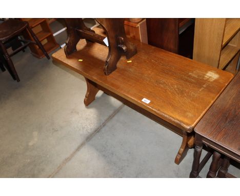An oak bench raised on stretcher base 