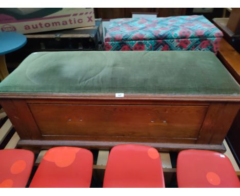 Antique storage trunk with padded material top. 