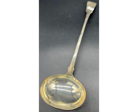 A Georgian Edinburgh silver large ladle produced by Andrew Wilkie. [36cm in length] 