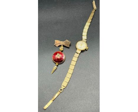 A Vintage ladies 9ct gold cased wrist watch produced by Sekonda. [Non Runner] Together with a Victorian Yellow metal brooch, 