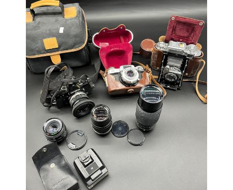Three vintage cameras and lenses to include Carl Zeiss Ikon Compur Rapid bellow camera, Carl Zeiss Contraflex Synchro- Compur