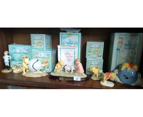 Shelf of Royal Doulton winnie the pooh figures includes Eeyore loses a tail , winnie the pooh clock etc 