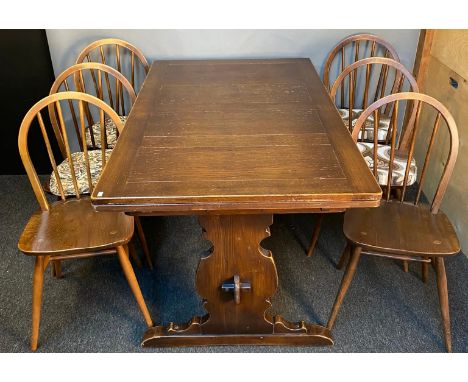 Vintage Ercol dark wood extending dining table with 6 matching Ercol spindle back dining chairs. [Table- 74x137x84cm] 