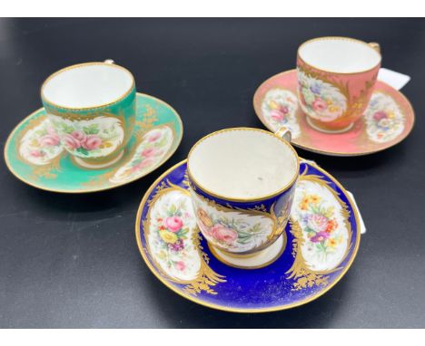 A lot of three Antique hand painted cups and saucers. Detailed with gilt trims and bouquets of hand painted flowers. In blue,