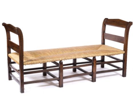 French  Fruitwood day bed, c1900 rush seat on stretcher supports, loose button squab cushion 197cm across