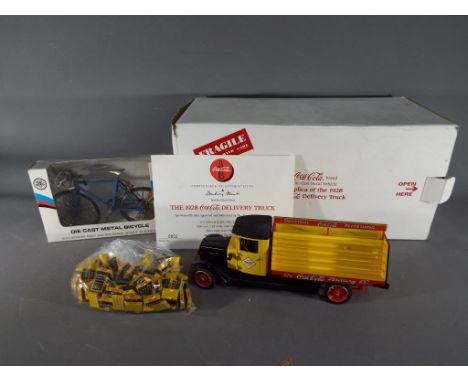 A Danbury Mint 1:24 scale diecast model of a 1928 Coca Cola delivery truck, with box and certificate of authenticity, also in