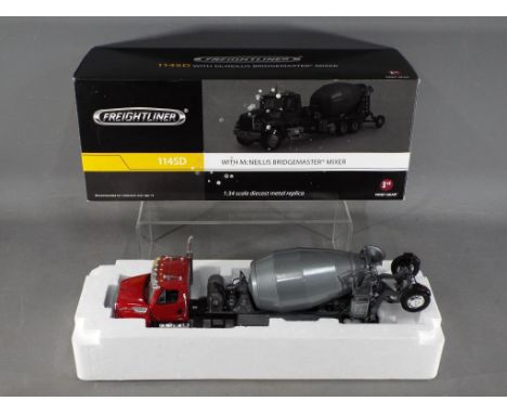 First Gear - A boxed 1:34 scale Freightliner 114SD with McNeilus Bridgemaster Mixer by First Gear. The model with red cab and