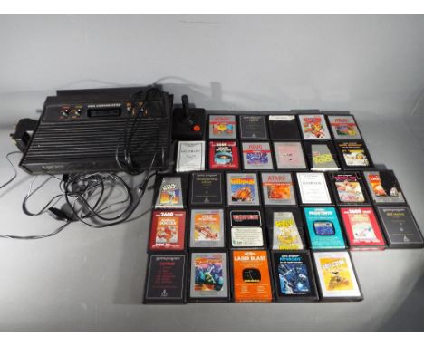 Atari - An Atari 2600 games console with controller and thirty game cartridges to include Donkey Kong, Pole Position, Star Wa