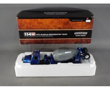 First Gear - A boxed 1:34 scale Freightliner 114SD with McNeilus Bridgemaster Mixer by First Gear. The model with metallic bl