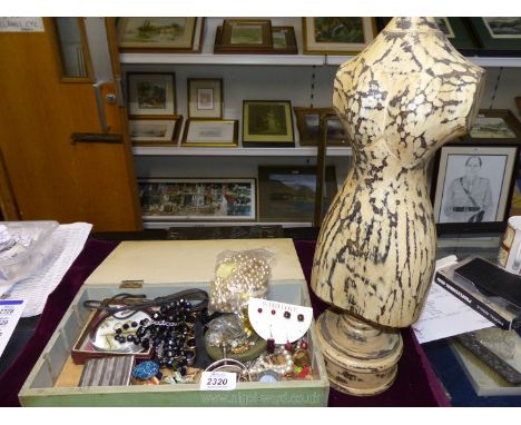 A quantity of costume jewellery and a wooden jewellery stand in the form of a mannequin.