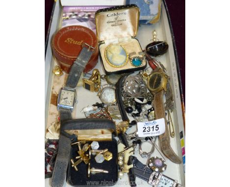 A small quantity of costume jewellery including cufflinks, brooches, watches, 'The Little Book of Gemstones' guide etc.