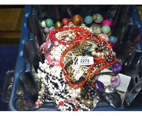 A quantity of costume jewellery including necklaces and chains.