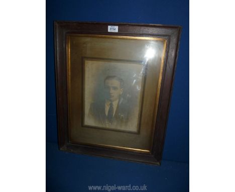 A large framed and mounted portrait of a young man.