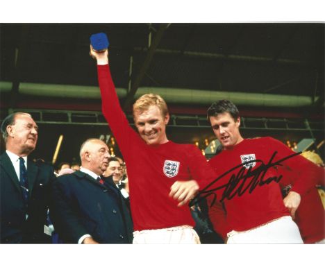 Football Geoff Hurst signed 12x8 colour photo pictured celebrating with Bobby Moore after the 1966 World Cup Final. Good cond