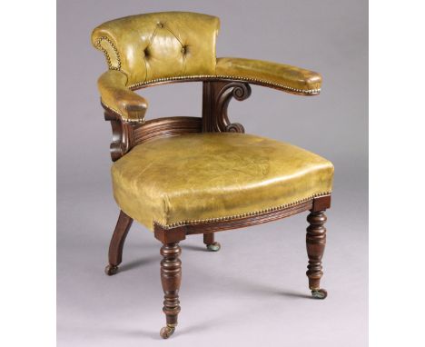 A Victorian mahogany elbow chair upholstered buttoned &amp; brass studded green leather , on turned front legs with ceramic c