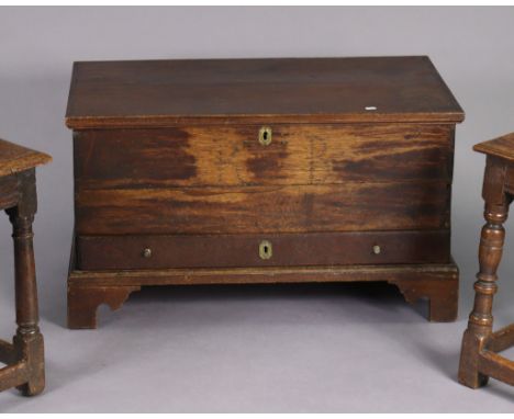 An 18th century oak small coffer or mule chest with moulded edge to the rectangular lift-top, fitted long drawer below with b