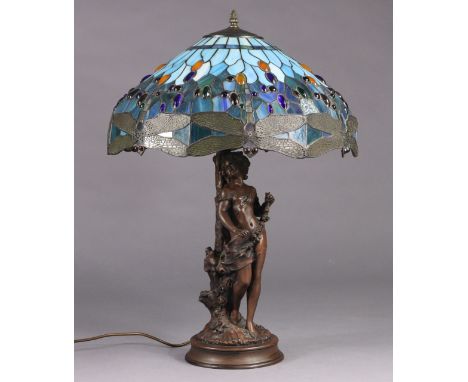 A Tiffany style stained glass table lamp with wide circular dragonfly pattern shade, on bronzed resin figural base, 20” wide 