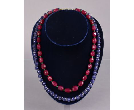 A necklace of opaque sapphire spherical beads, 22½” long; &amp; another of facetted ruby beads, 20” long.