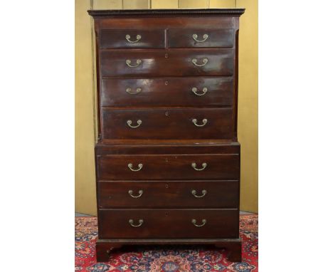 A late 18th century mahogany chest-on-chest with moulded dentil cornice above two short &amp; six long drawers with brass swi