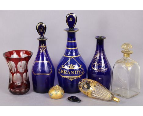 A 19th century blue glass “Brandy” decanter with gilt painted decoration and flat-sided pear-shaped stopped (chipped, 11” hig
