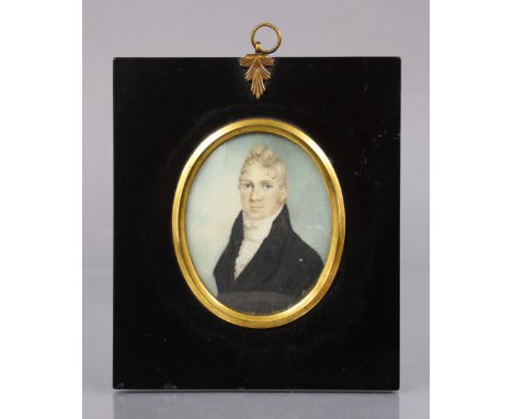 ENGLISH SCHOOL, early 19th century. A portrait miniature of a gentleman with curled blonde hair, wearing black jacket and whi
