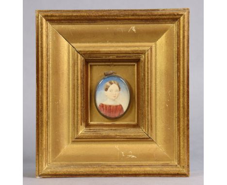A 19th century portrait miniature of a young girl with short hair &amp; wearing red dress, 2”x1½”, in brass oval frame mounte