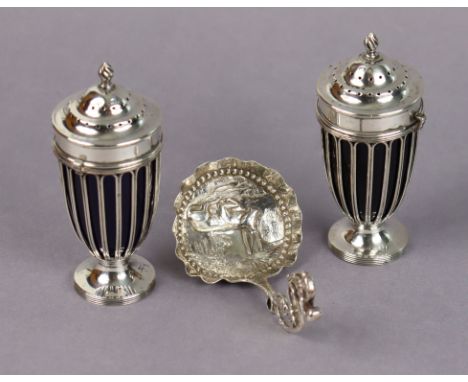 A pair of Edwardian silver vase-shaped wirework pepper pots with flame finials to the pull-off lids, each on circular foot &a