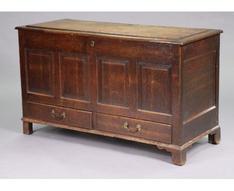 A late 18th century oak mule chest with hinged lift-lid, the fielded four-panel front above two short drawers with brass swan