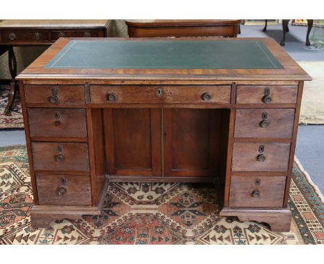 A Victorian mahogany kneehole desk inset gilt-tooled green leather to the top, fitted with an arrangement of nine graduated d