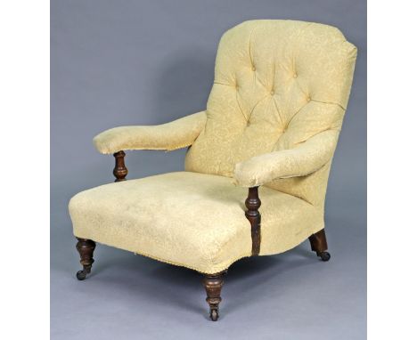 A Victorian walnut armchair upholstered ivory floral fabric, the padded open arms on turned supports, with low swept seat &am