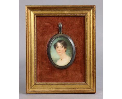 A 19th century portrait miniature of a lady, her dark brown hair in short curls, 2¼”x1¾”, in brass oval frame mounted to fabr