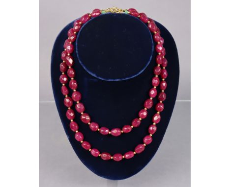 A necklace of opaque ruby oval facetted beads, 19¾” long; &amp; a similar necklace, 16½” long.