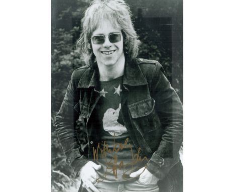 Elton John signed 12x8 inch black and white vintage photo. Good condition. All autographs come with a Certificate of Authenti