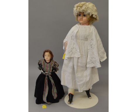 A 30" shoulder head wax over composition doll on stuffed body. Composition limbs and booted feet. Damage to hands and toes of