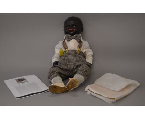 K&R Black boy character doll, composition head, restoration to arms and ankles, including the dolls original silk onesie. 