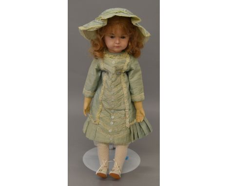 Reproduction K&R "Mein Liebling" doll head on Kid leather body, composition limbs, silk dress and hat. 