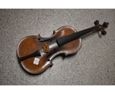 A traditional violin having inch bowed back, label unclear (Stradivarius copy), no case , sold with a traditional violin bow