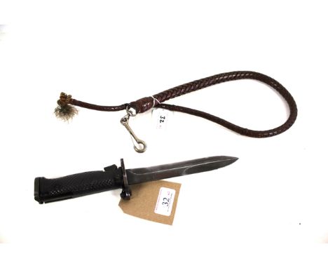 A U.S. M5A1 bayonet (no scabbard) with a small leather whip